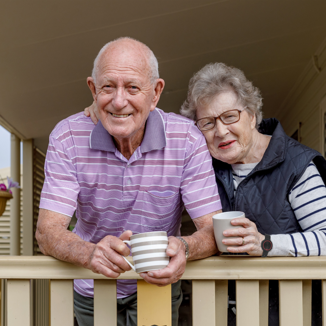 Senior couple drinking tea on porch - 1